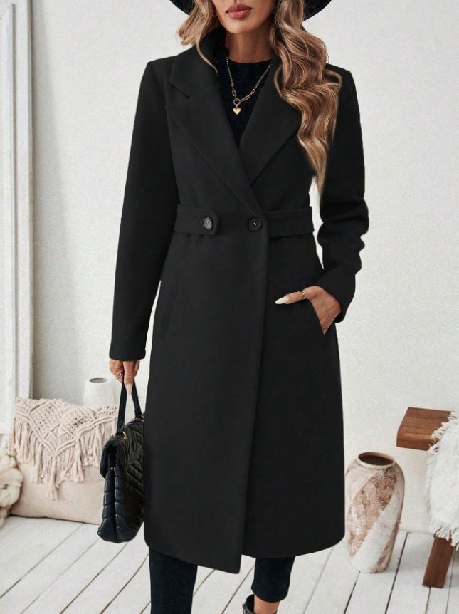 Black wool long double-breasted coat with notched lapels and flap pockets, button front.
