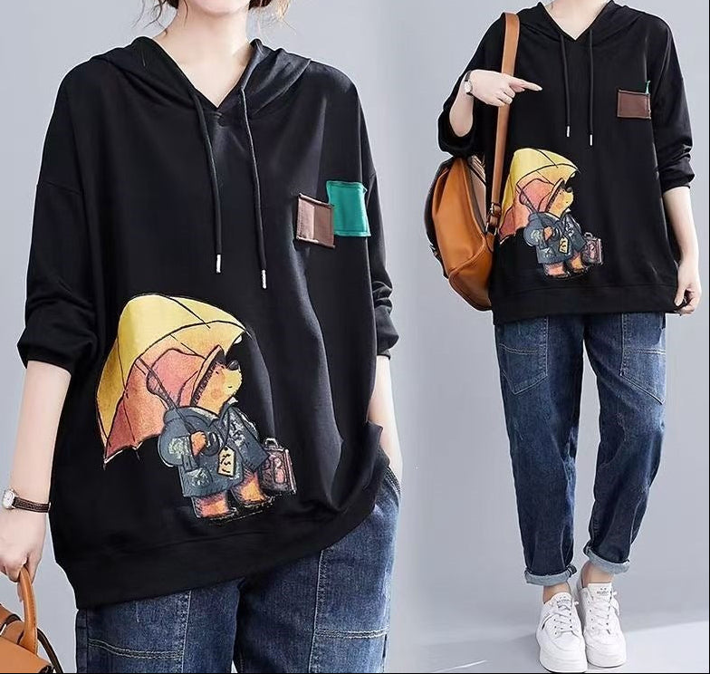 Black hoodie with hood and drawstrings, graphic front print, and kangaroo pocket
