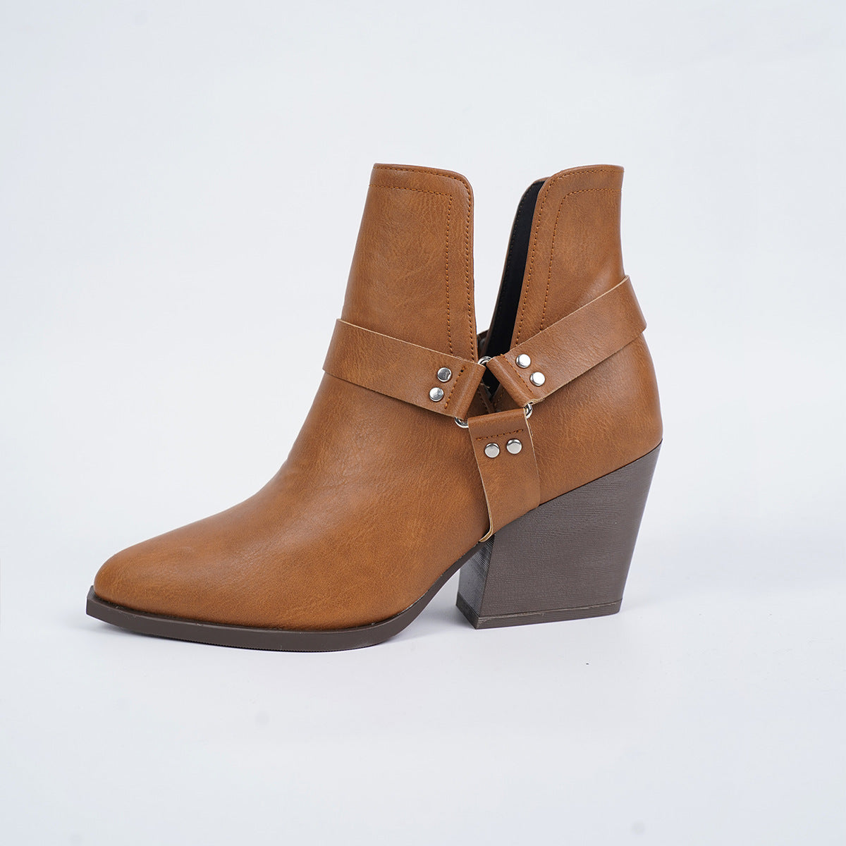 Brown pointed-toe ankle boots with side buckle harness straps and block heel
