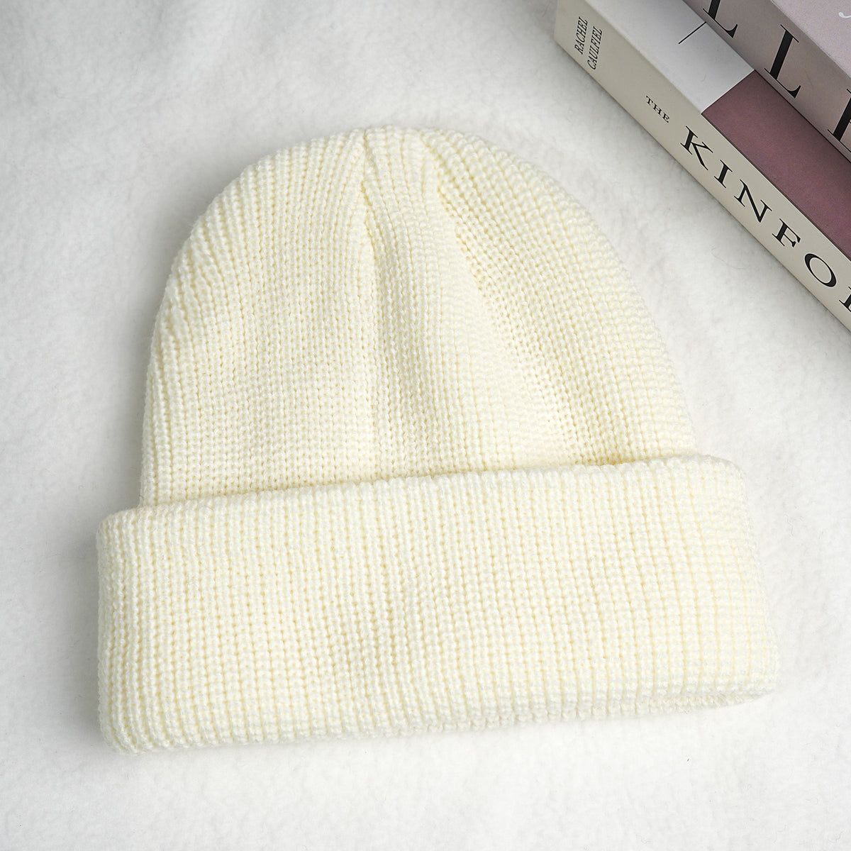 Cream thick ribbed knit beanie hat with folded cuff.