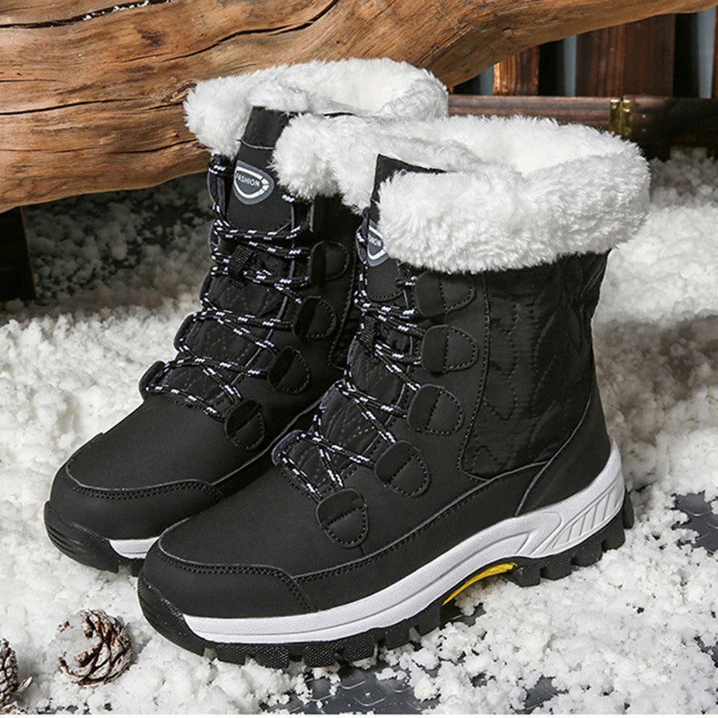 Women's mid-calf snow boots in black, quilted lace-up design, faux-fur cuffs, rubber sole.