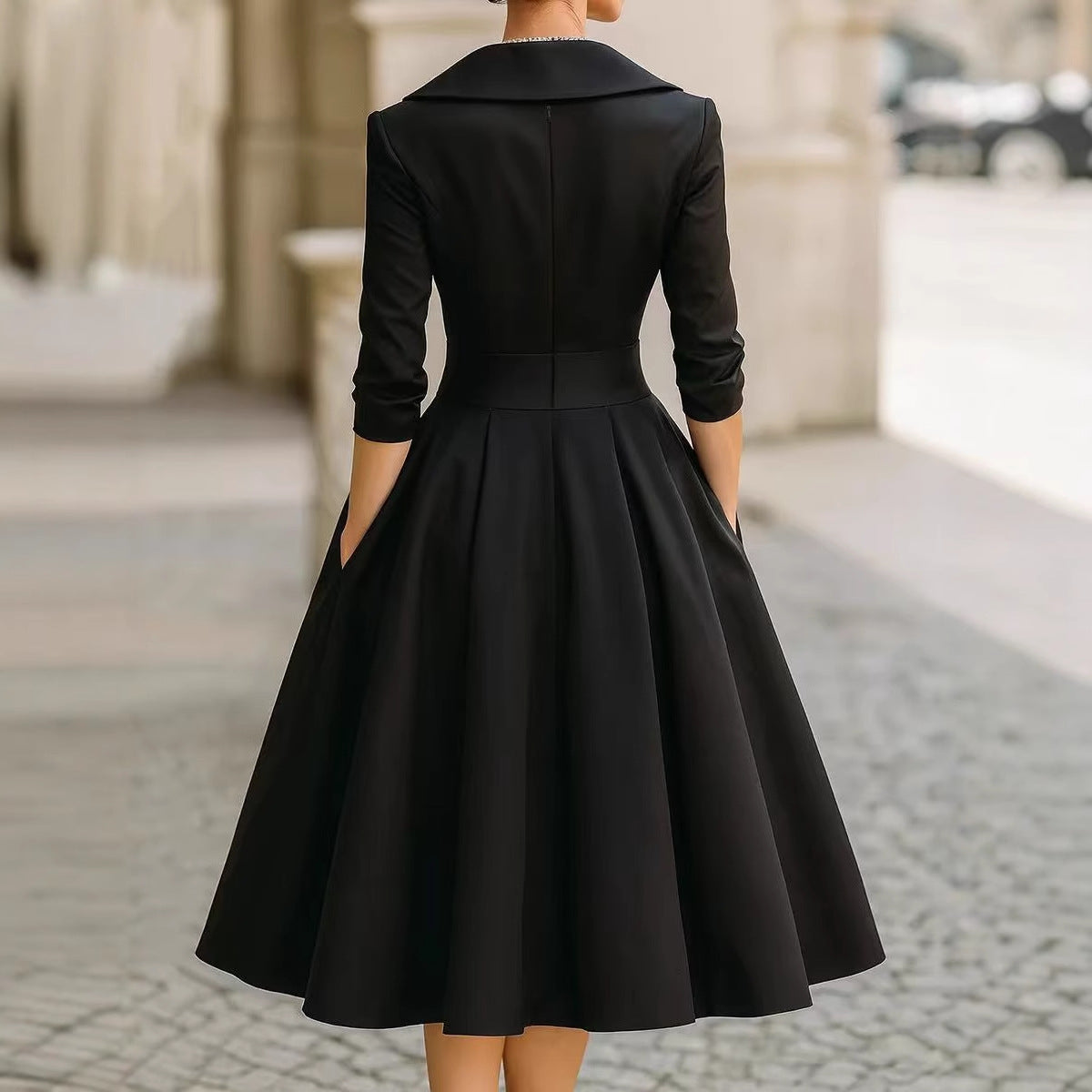 Women’s waist-cinching dress, black, long sleeves, back view with flared A-line hem.