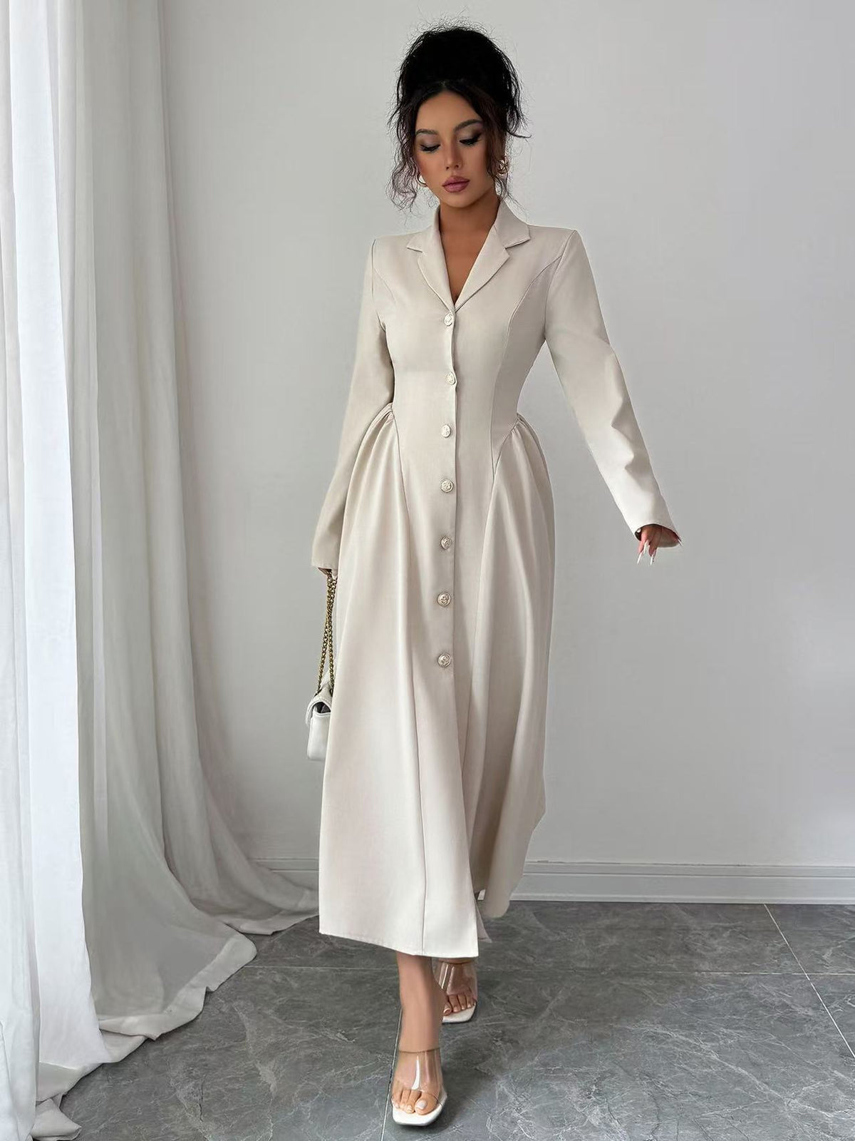 Off-white V-neck long-sleeve button-front dress with fitted waist, over-the-knee length