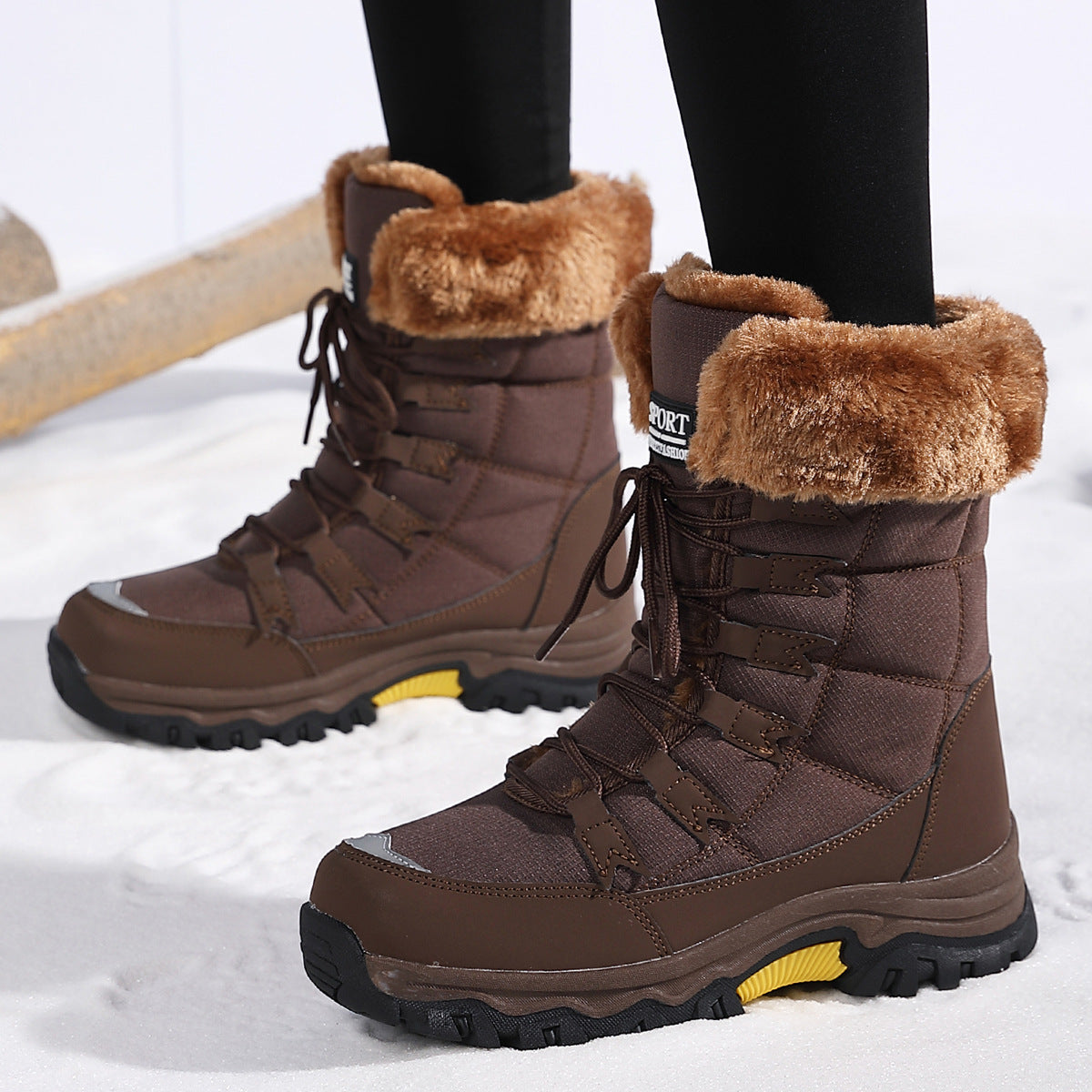 Brown lace-up snow boots with fuzzy cuffs, rugged tread, and yellow side trim