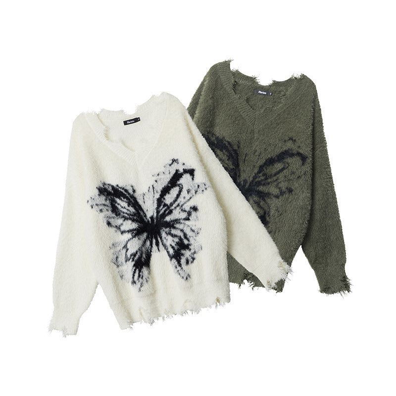 Two-tone view: cream and dark green fuzzy pullover sweaters with black butterfly graphics