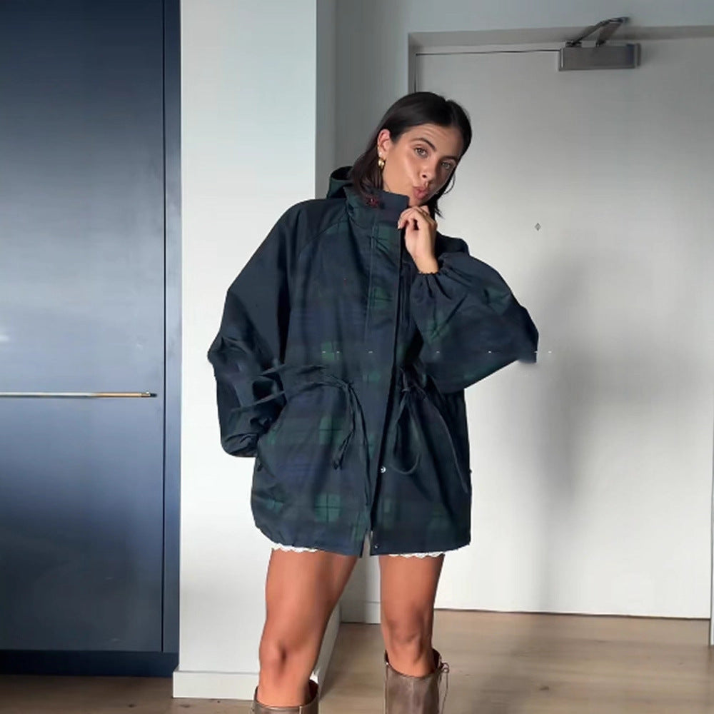 Dark blue hooded windbreaker parka with stand collar, green plaid panels, drawcord waist