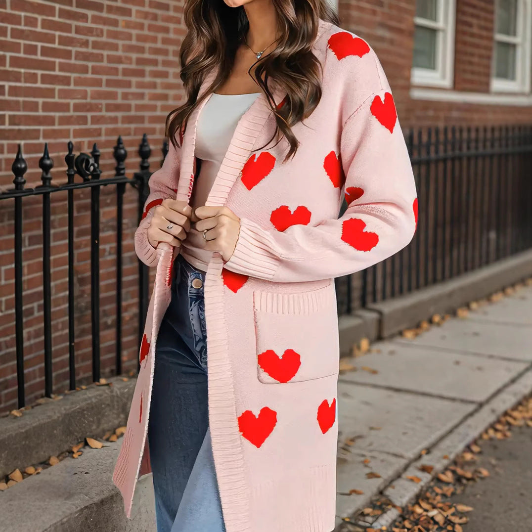 Pink heart-print knit cardigan with open front and long sleeves, mid-length topper