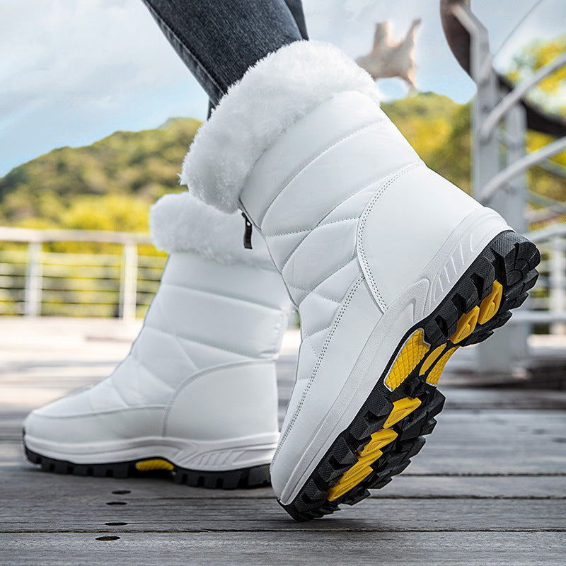 White quilted snow boots with faux-fur trim, thick lug tread sole with yellow accents