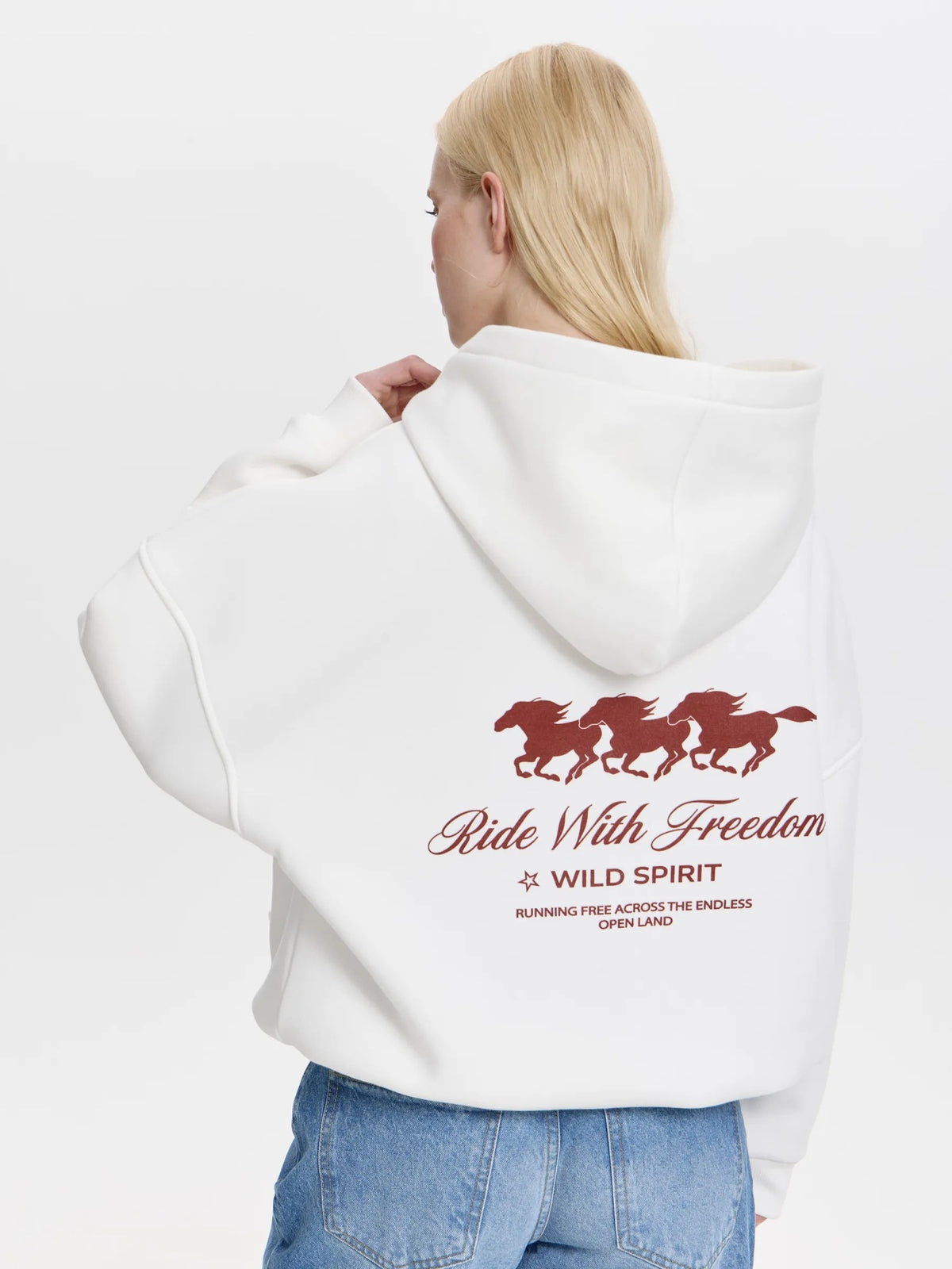 White oversized hoodie with back horse graphic and 'Ride With Freedom' slogan