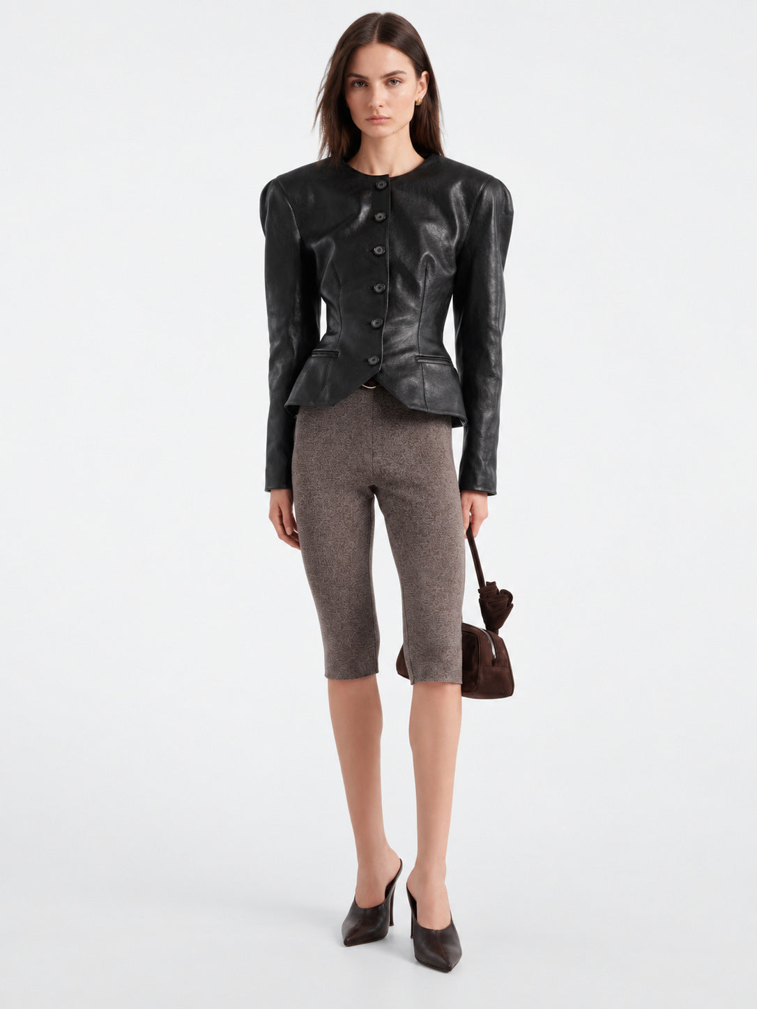 Women’s black leather jacket with button front, fitted peplum hem and side pockets.