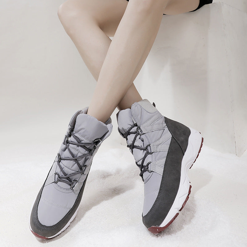 Gray lace-up snow boots with padded ankle cuffs and dark side panels, red tread sole
