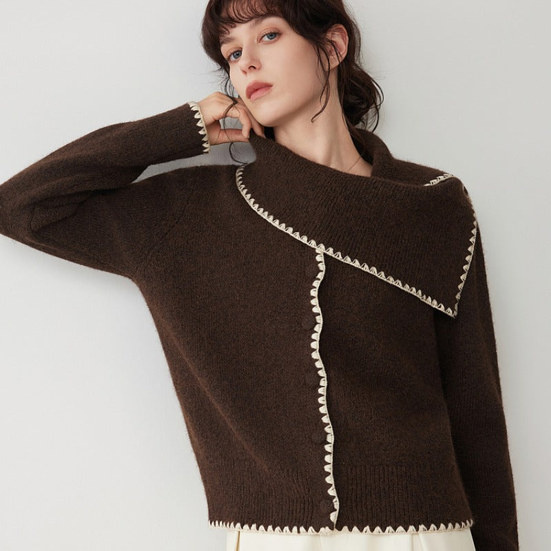 Women’s dark brown knit sweater with diagonal panel, white scalloped trim and long sleeves