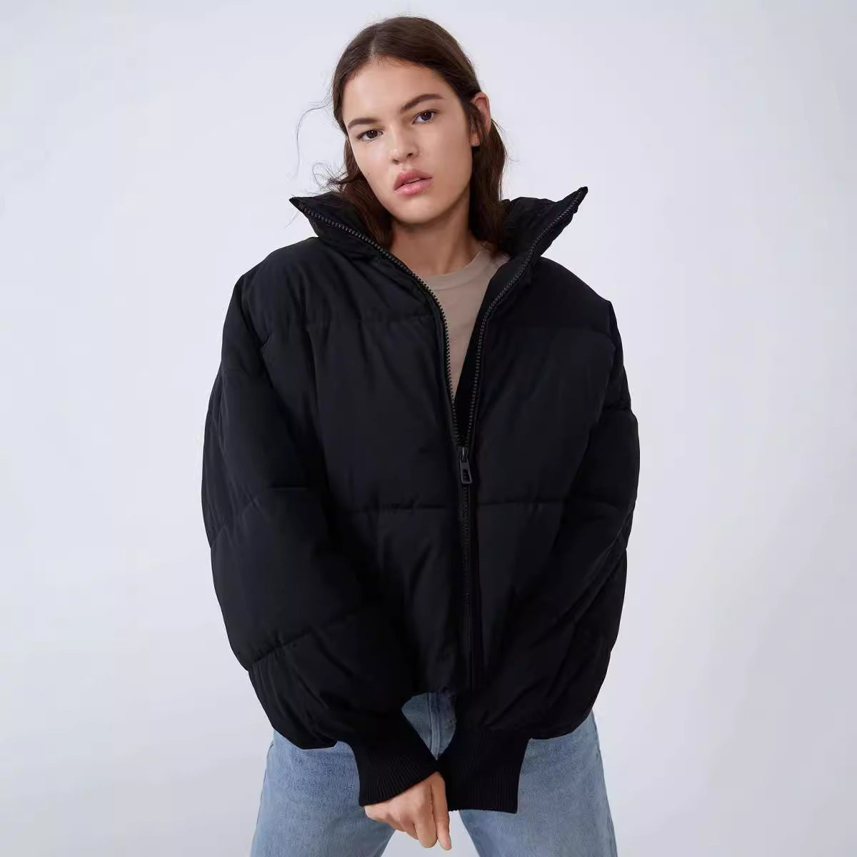 Women's black zip-front puffer jacket with stand collar and side pockets
