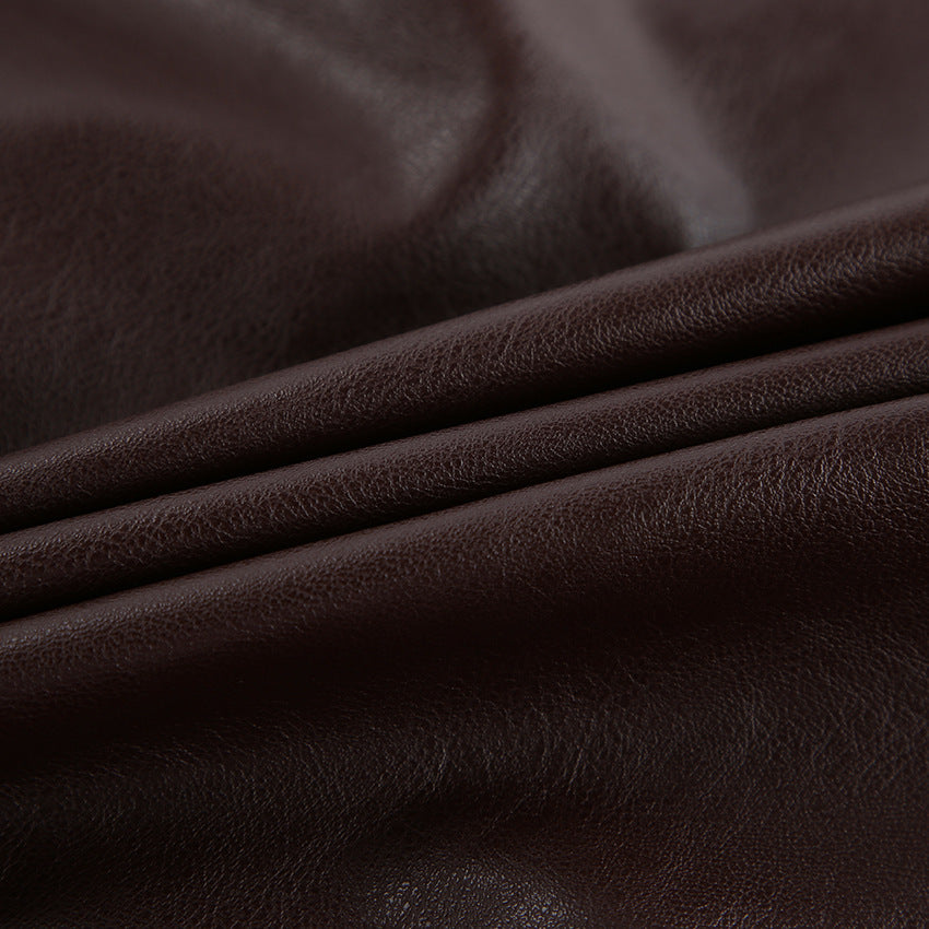Brown leather fabric close-up with subtle grain texture