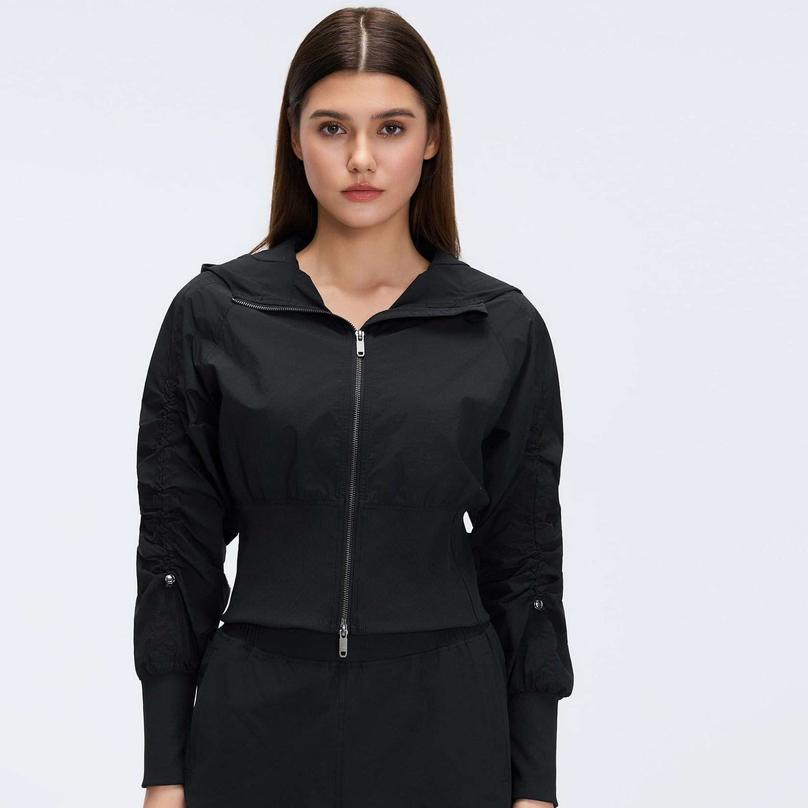Black cropped hooded zip-up windbreaker with long sleeves and front zipper