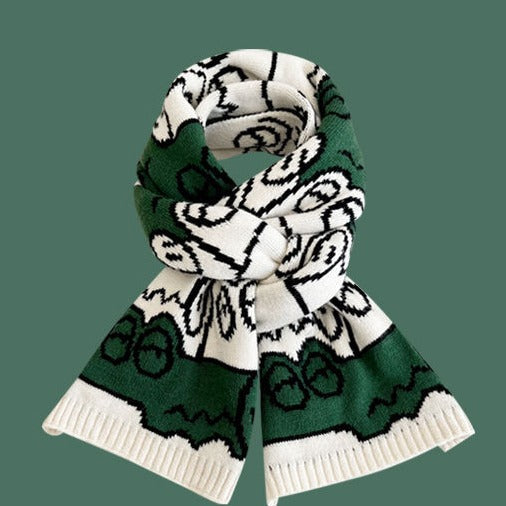 Cream, black, and green patterned knitted scarf with ribbed hem and wrapped look
