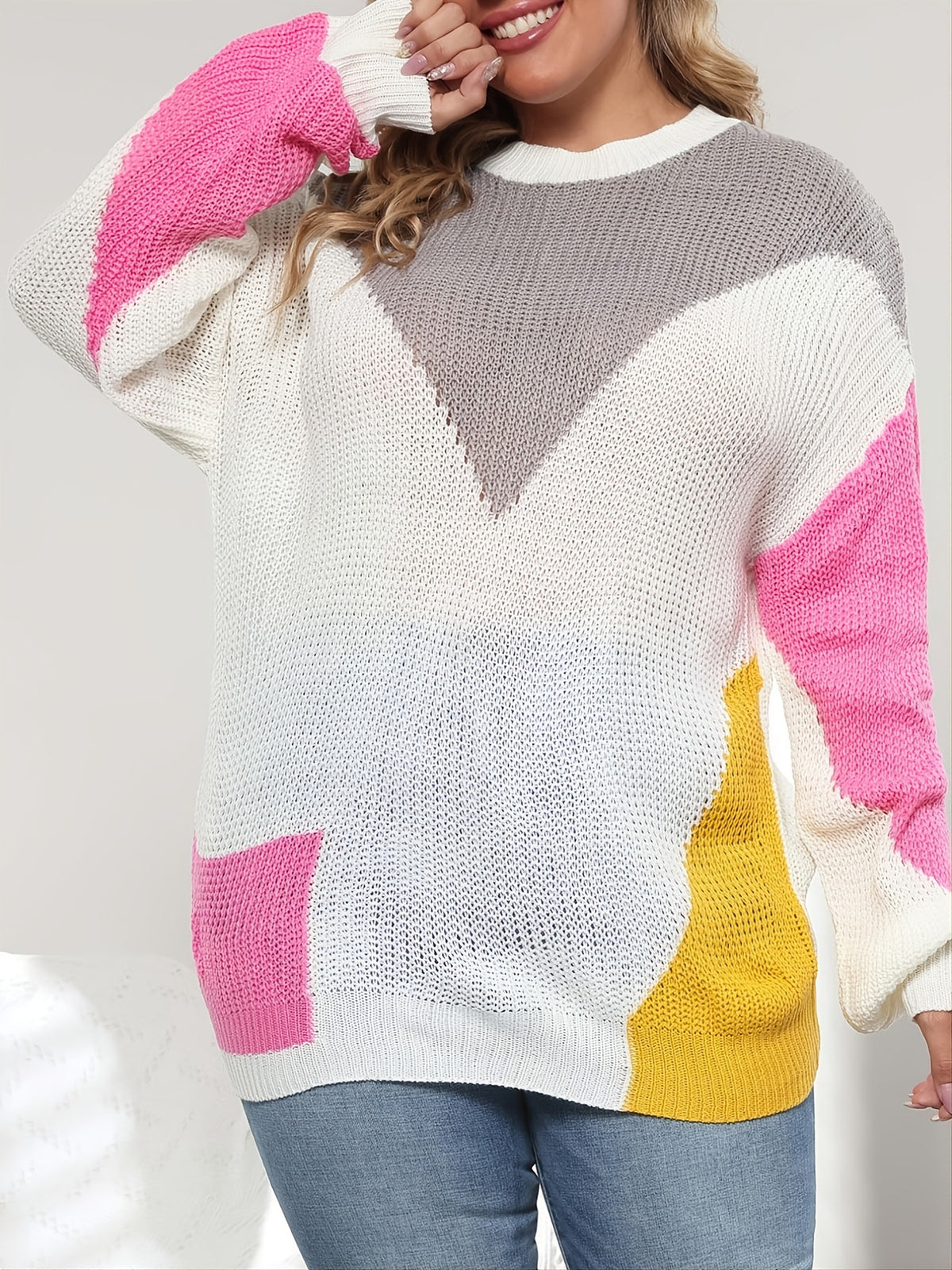 White plus size knit sweater with gray chevron and pink and yellow contrast stitching