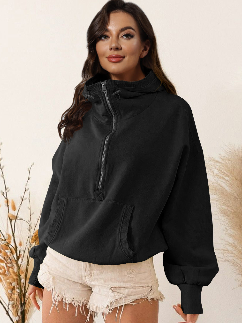Black hooded zip sweatshirt with drawstring and front kangaroo pocket