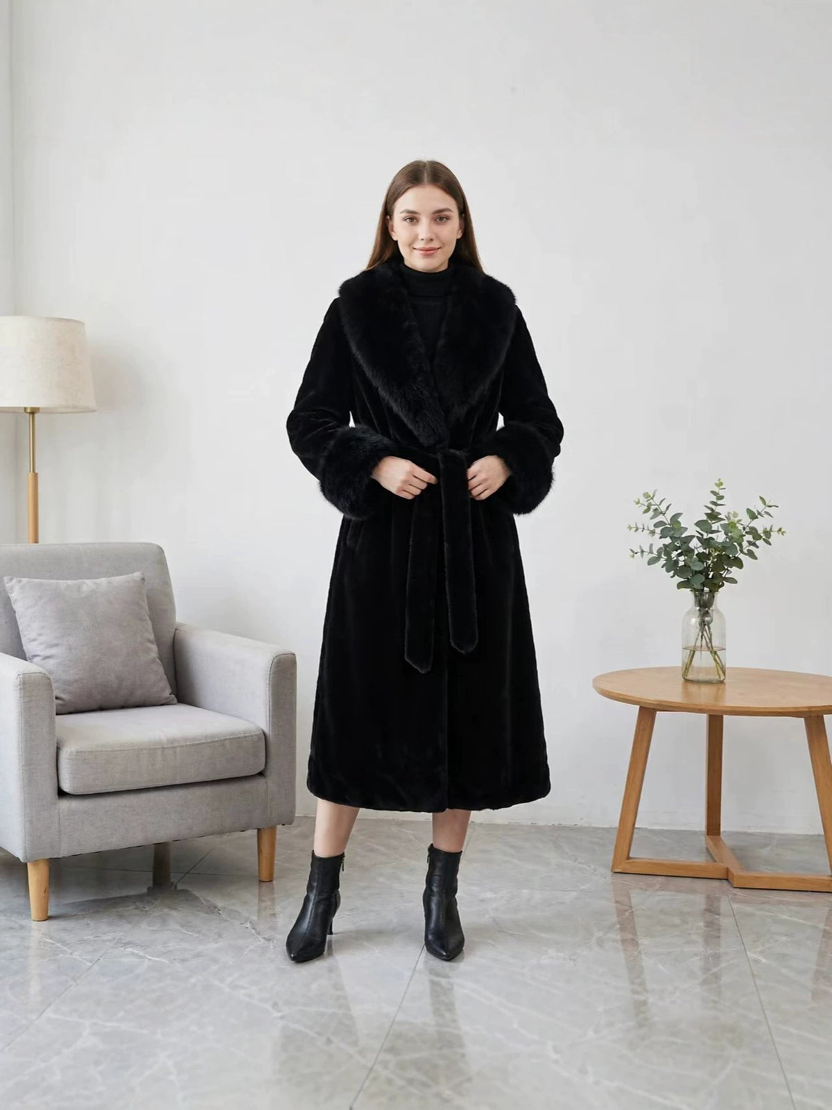 Black faux leather trench coat with plush fur collar, belted waist and midi length