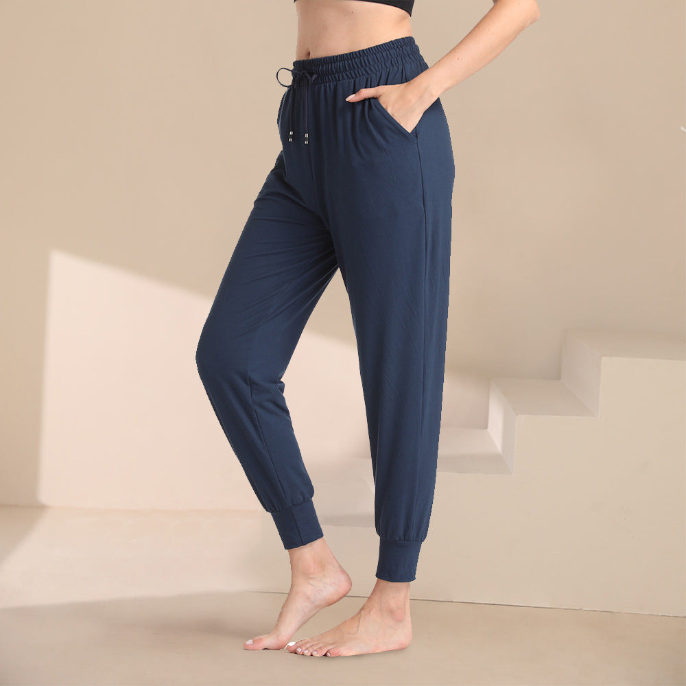 Navy blue jogger pants with elastic waist, drawstring, and tapered ankle cuffs