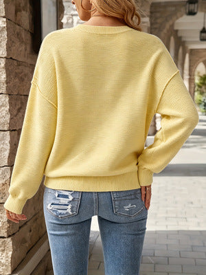 Yellow knit sweater back view, round neck, drop shoulders, ribbed cuffs