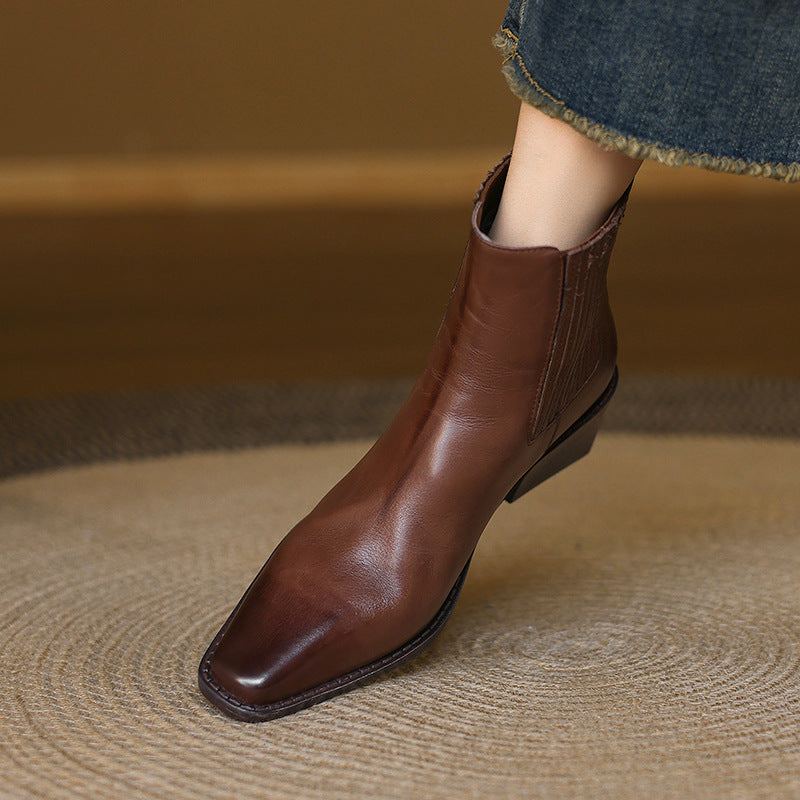 Brown leather Chelsea boots with square toe and thick heel, angled side view