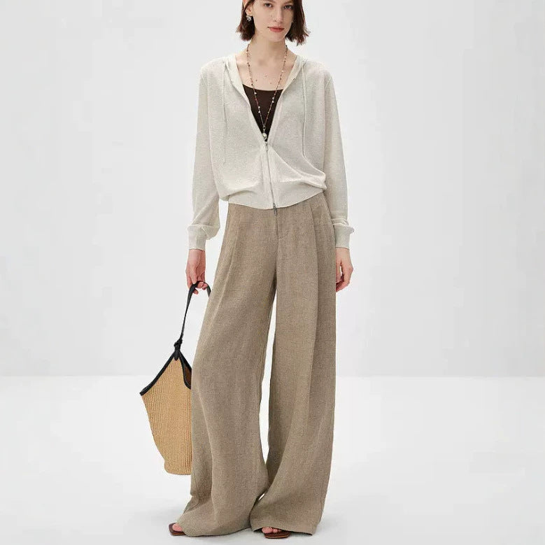 Light beige knit cardigan with zip front and V-neck, worn with wide-leg pants