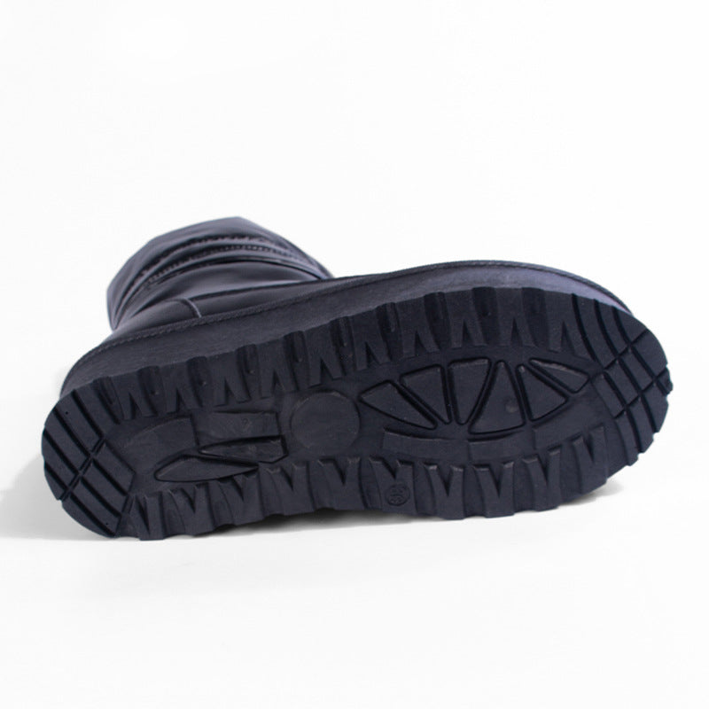 Women's black snow boot outsole with textured tread, thick platform sole