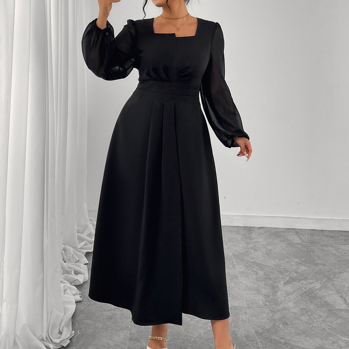 Black long-sleeve midi dress with square neckline and pleated high waist