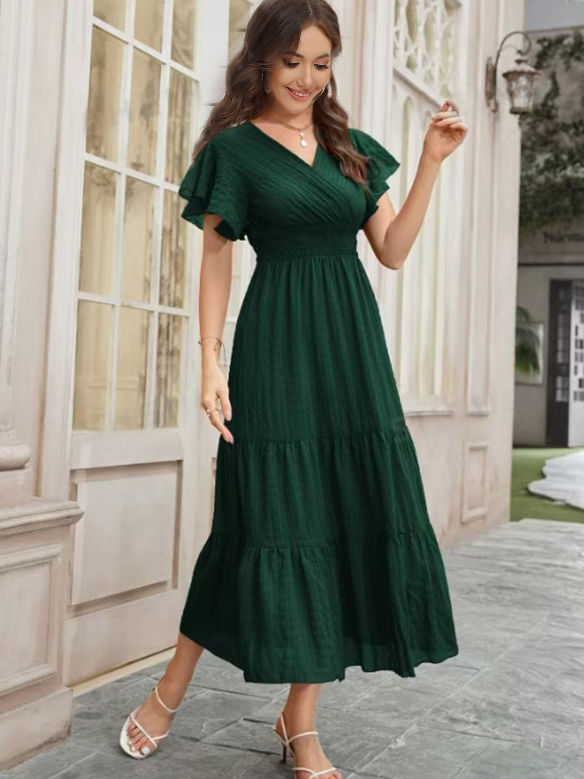 Dark green V-neck tiered midi dress with flutter sleeves and layered hem