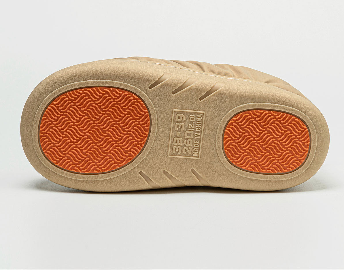 Men's beige slipper outsole with textured tread and brand mark detail