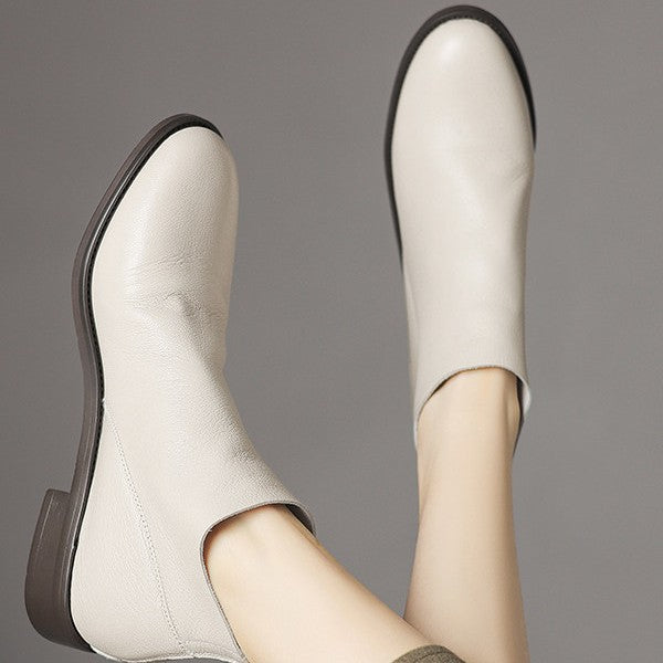 Women’s off-white short ankle boots, curved toe and low chunky sole.