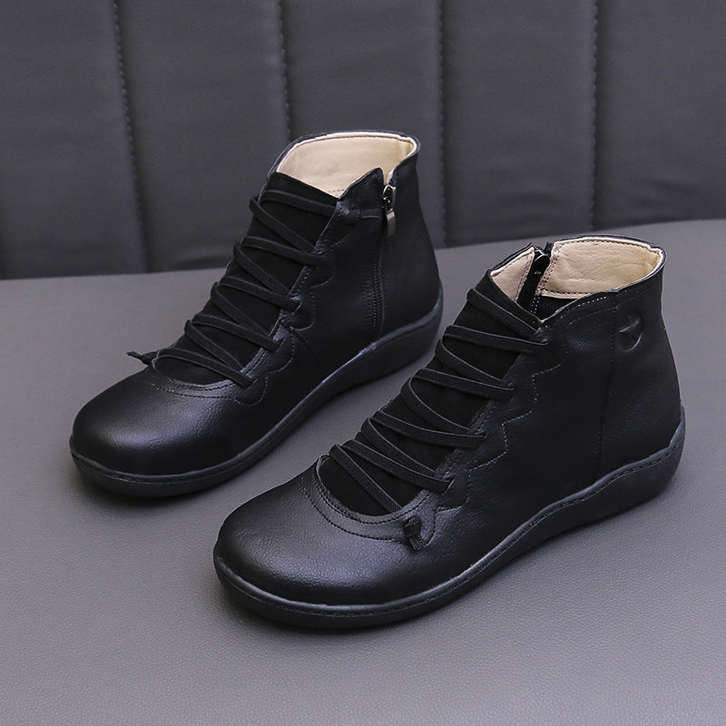 Black women's ankle boots with flat soles, lace-up fronts and side zippers.