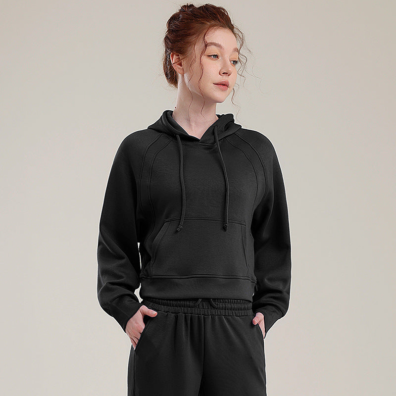 Black hooded tracksuit set with kangaroo-style pocket, drawstring hood, and elastic waist
