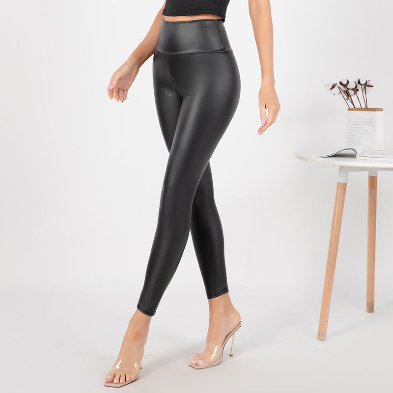 Black matte faux leather high-rise leggings with slim, straight legs and smooth seams.