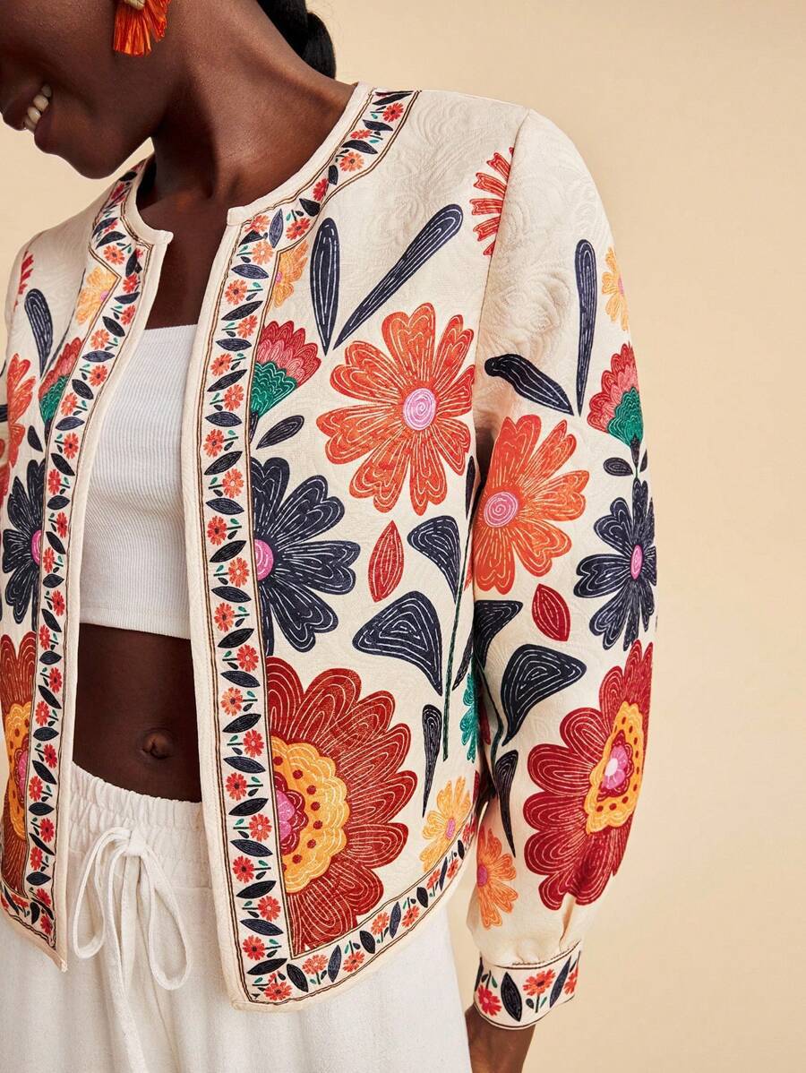 Women’s floral jacket cardigan close-up, cream base with orange and blue flower print trim