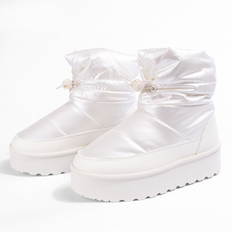 Women's off-white mid-top snow boots with bow details and thick platform soles