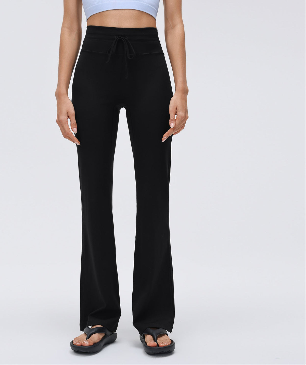 Black high-waisted drawstring flared yoga pants with wide-leg flare and athletic fit