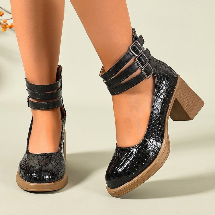 Black textured platform pumps with two strap buckles and chunky mid heel