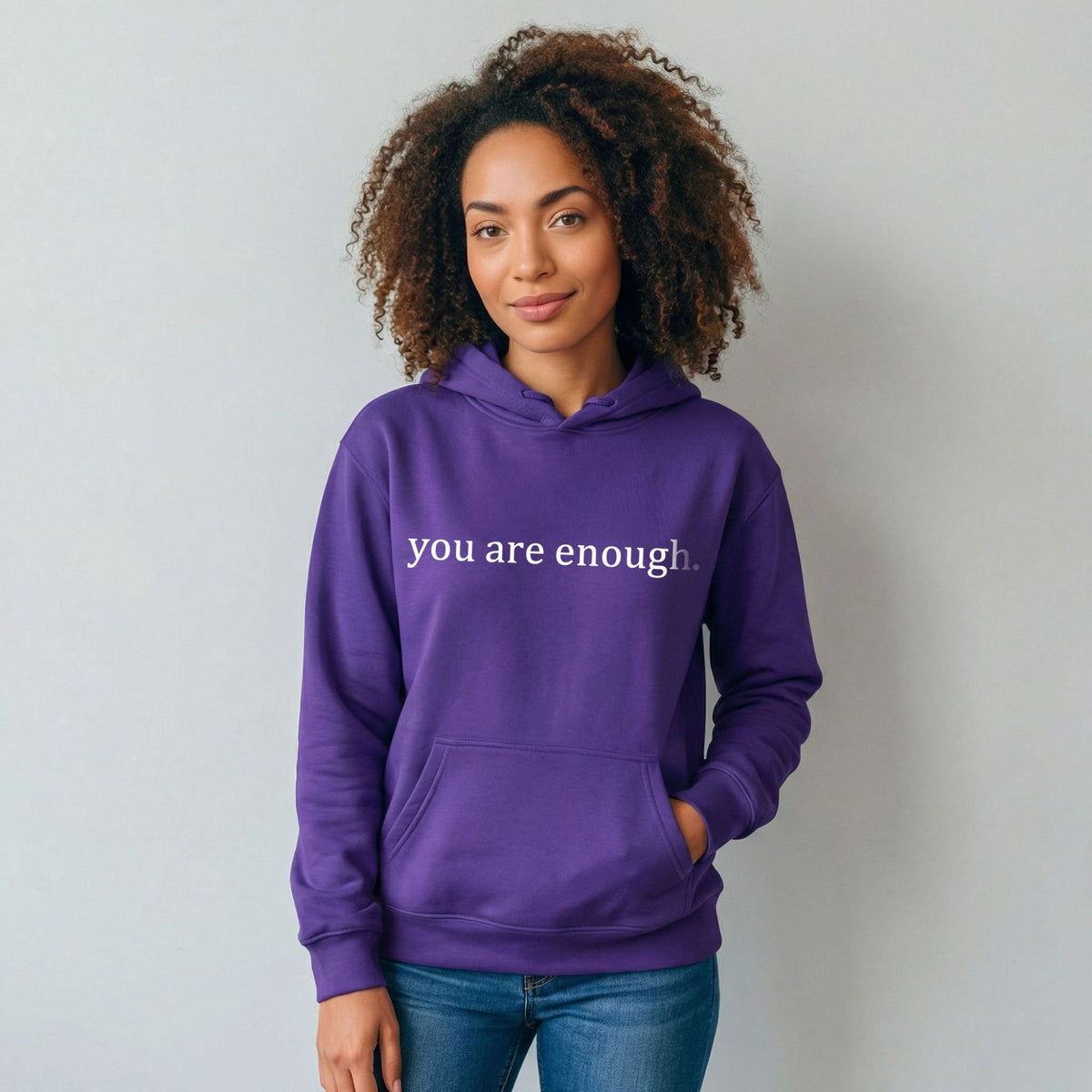 Purple women’s hoodie sweatshirt with hood, front pocket, and 'you are enough' print.