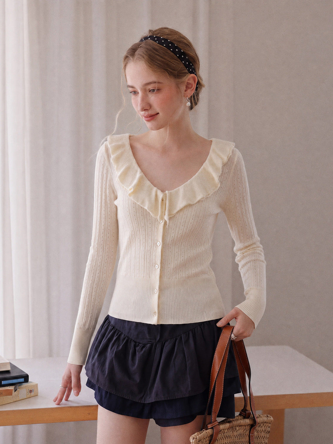 Off-white long-sleeve knit V-neck button top with ruffled collar