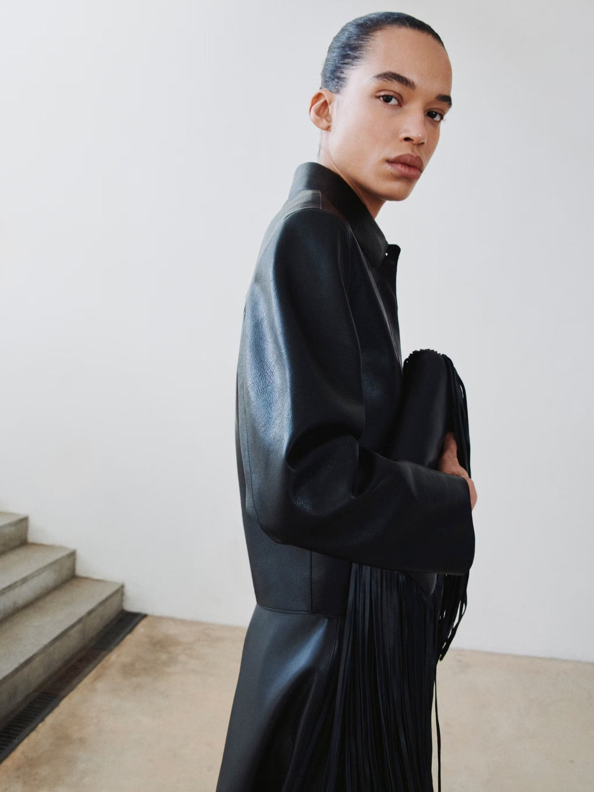 Women's black leather jacket with stand collar, dropped shoulders, long sleeves