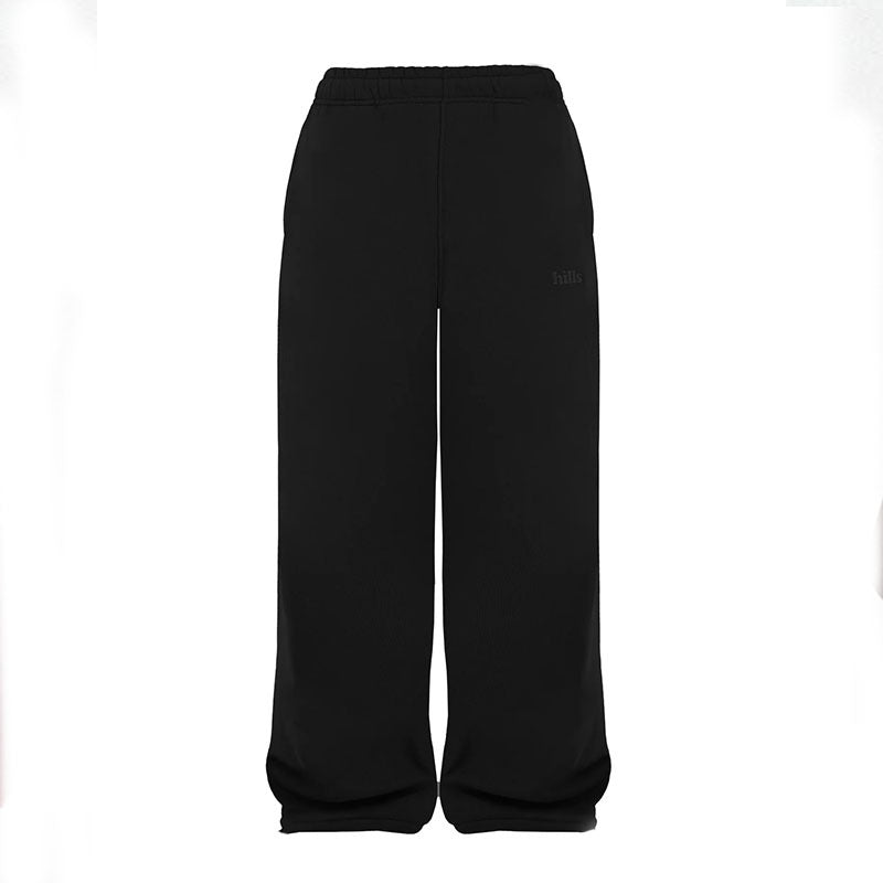 Black sweatpants with elastic waistband and relaxed wide-leg fit