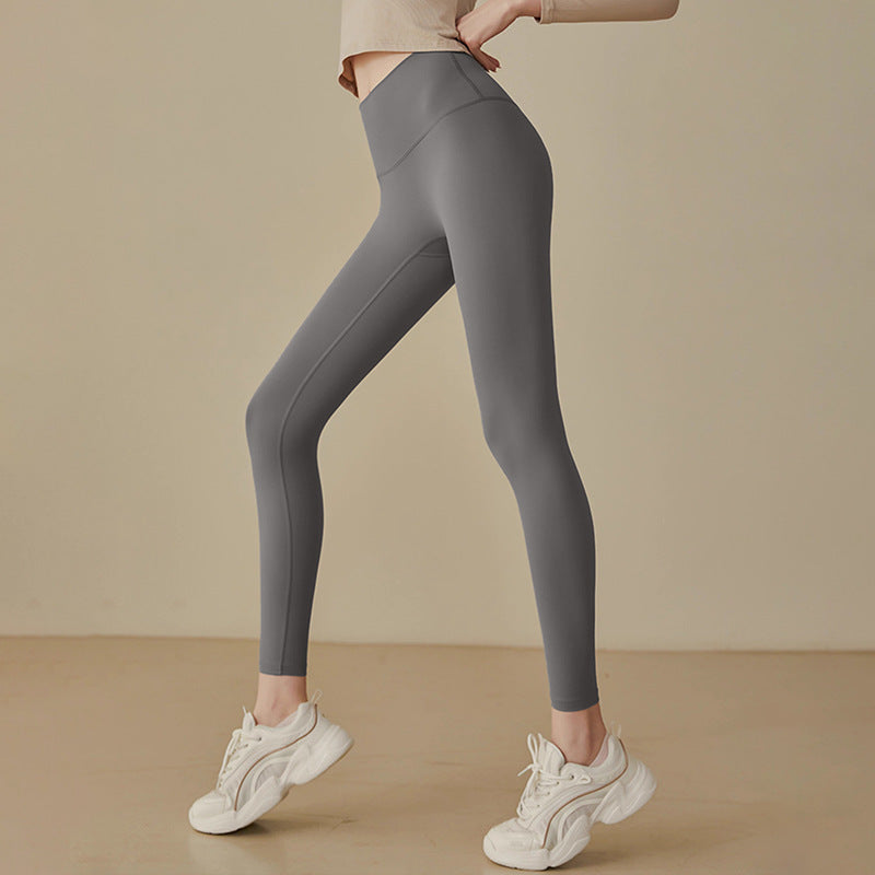 High-waisted yoga leggings in gray, full-length stretchy fit with smooth seams
