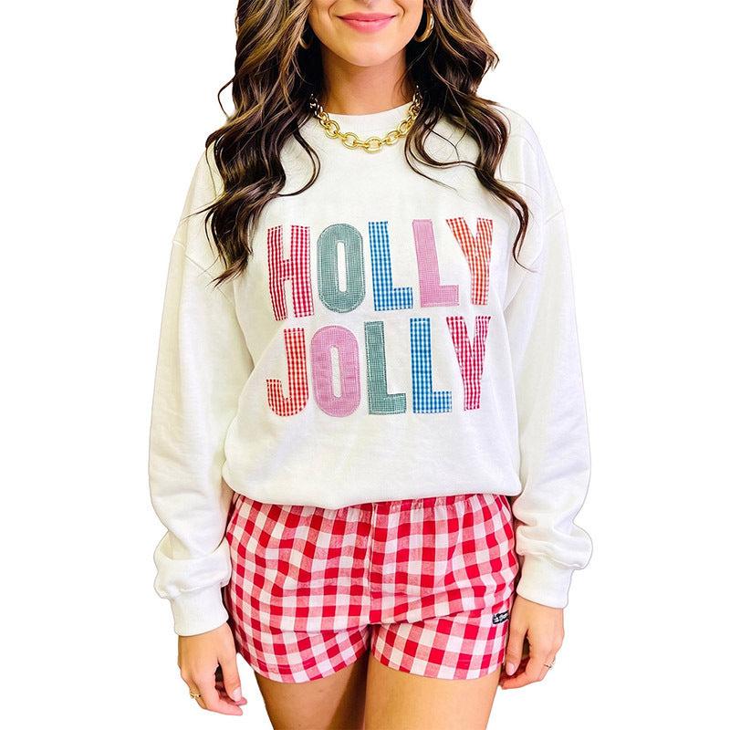 White oversized long-sleeve pullover sweatshirt with multicolor 'HOLLY JOLLY' check print
