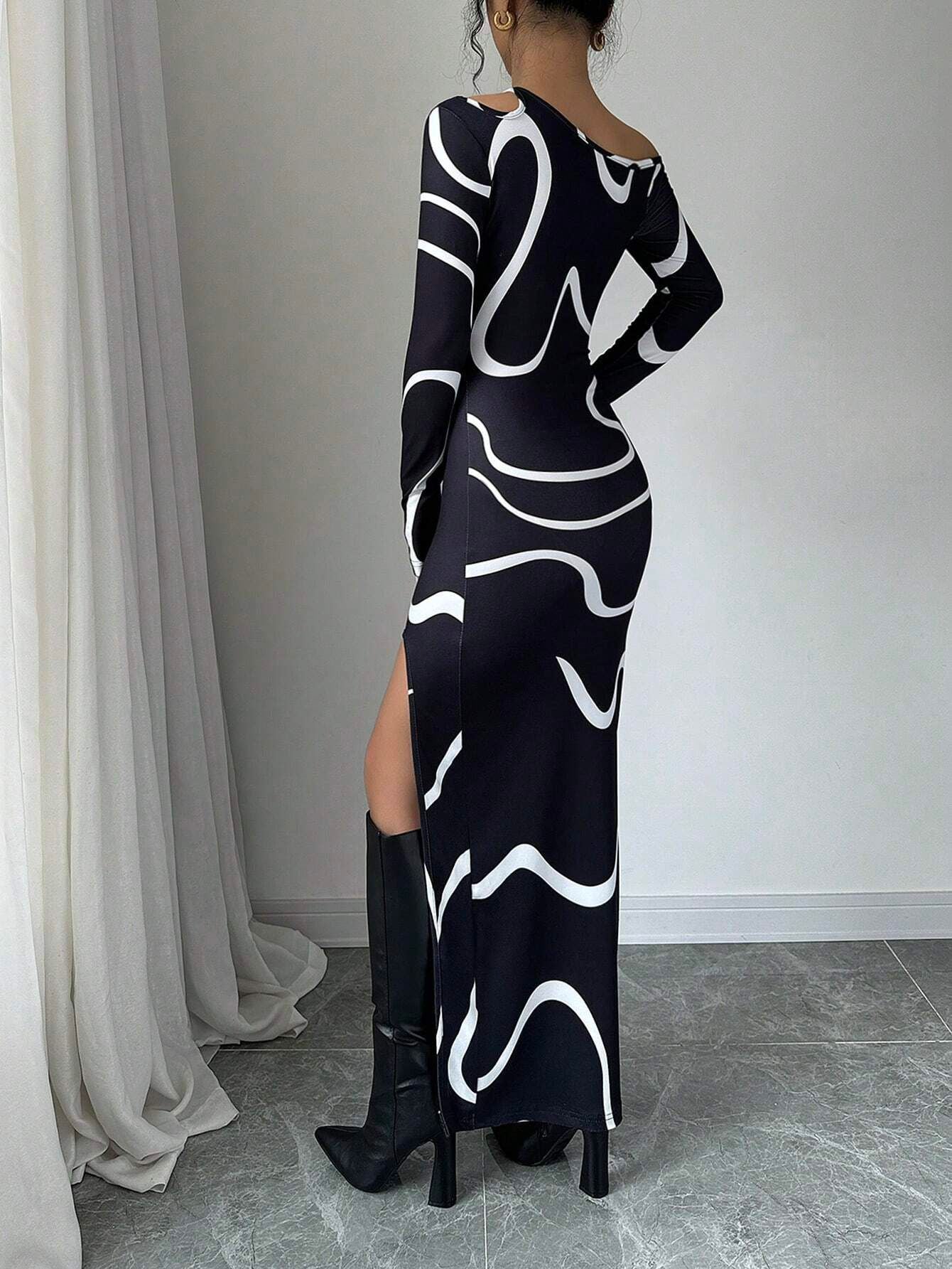 Black off-shoulder maxi dress with white abstract curves, long sleeves, side slit