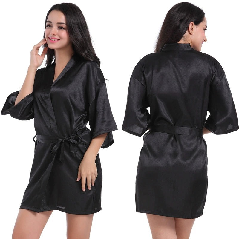 Black satin short robe with V-neck and tied waist belt, half sleeves.