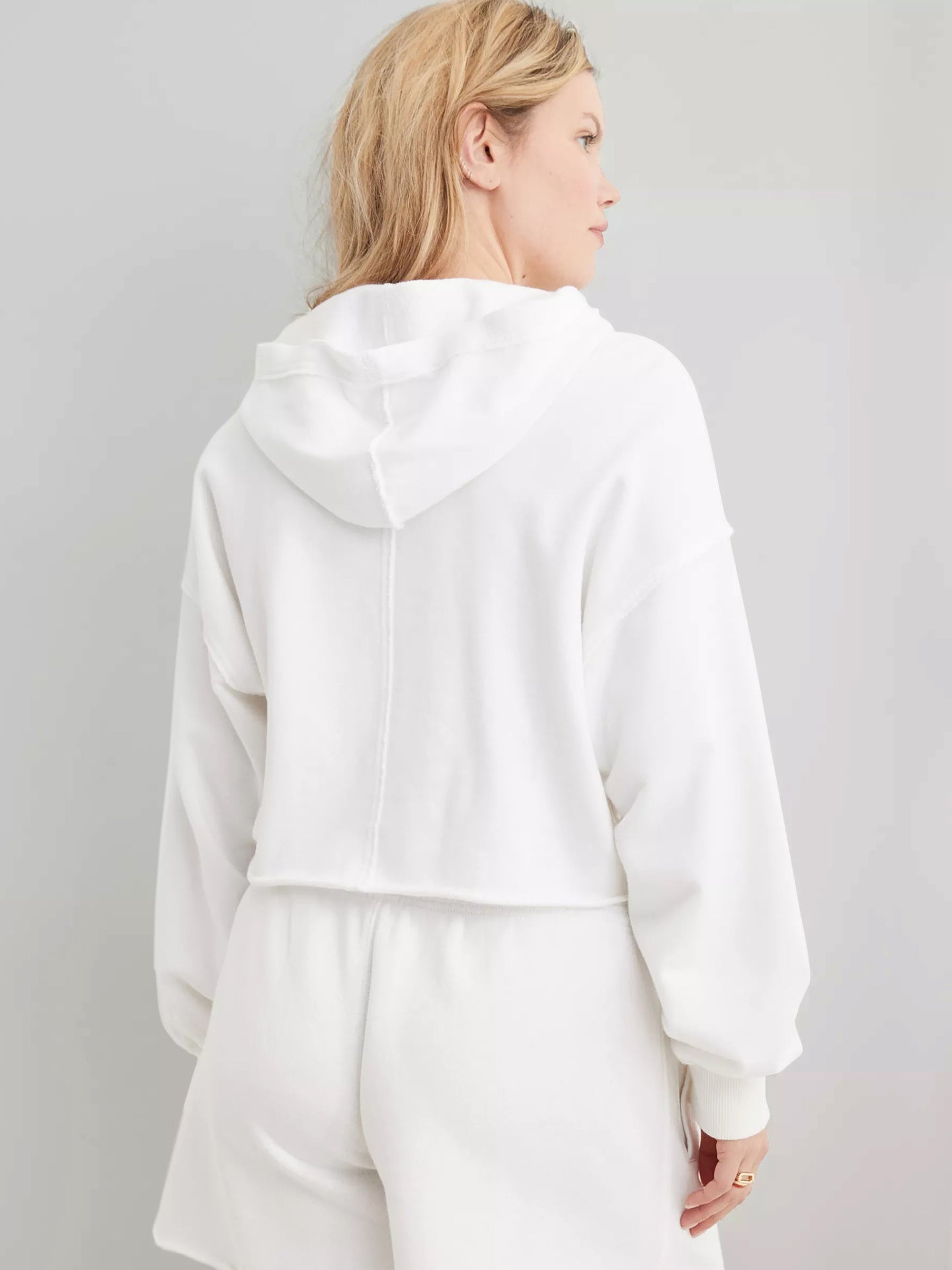 Women's white hooded pullover sweatshirt with long sleeves, back view