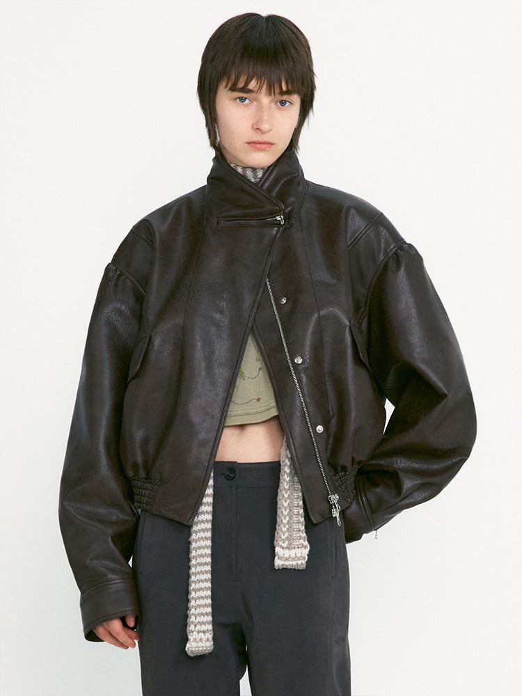 Women's black leather jacket with stand collar, zip front, snap placket, knit scarf