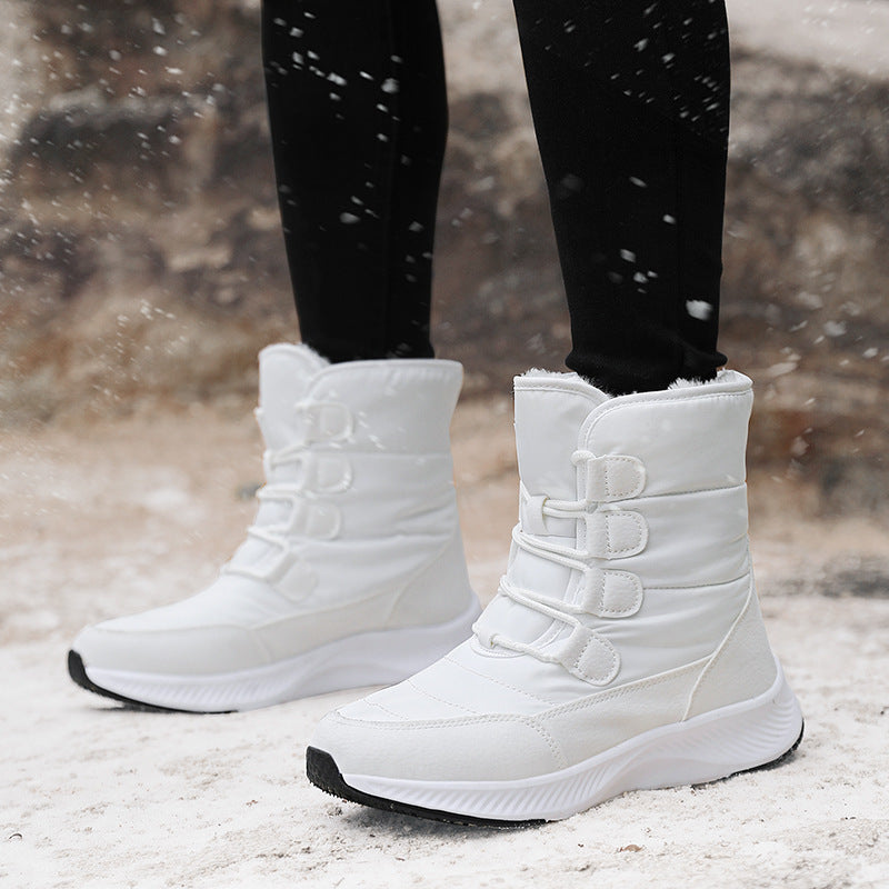 White high-top winter snow boot with fleece lining, hook-and-loop straps, and thick sole
